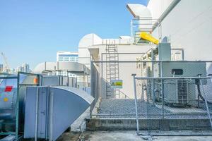 The industrial machine at the rooftop of the huge building. photo