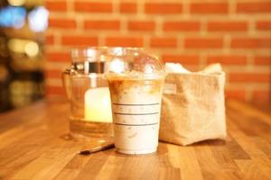 Take away Latte with Brick background on the wood table photo