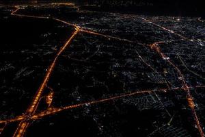 Night view from the jetplane in twilight time with the red sky and light of the city. photo