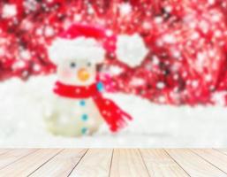 White wooden planks blurred snow man on a white background and red decorated Christmas and New Year. photo