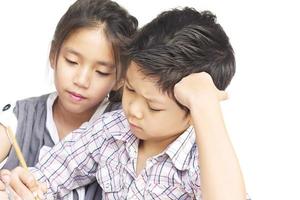 Kid are doing homework together over white background photo