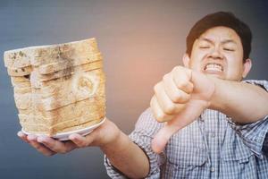 Man showing old fungi decay bread photo