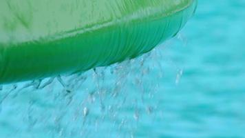 Close-up shot of water dripping from a mushroom-shaped fountain at a water park. video