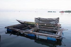 This is Keramba, a traditional fish farming tool that floats in the middle of the sea, made of nets for raising fish photo