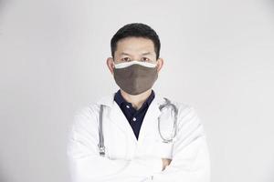 Asian doctor is wearing double layer masks for protecting Covid-19 virus - medical people working concept photo