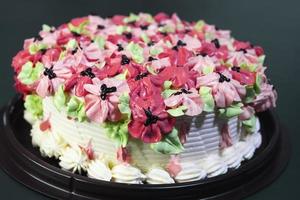 Beautiful butter cake with colorful pink flower decoration on top photo