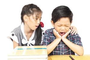 Sister try to teach her naughty younger brother to read a book isolated over white background photo