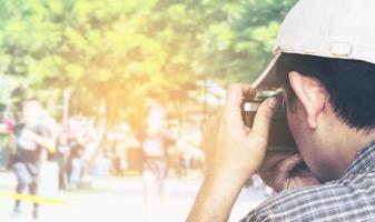 Man holding film camera ready to take photo over sport competition background