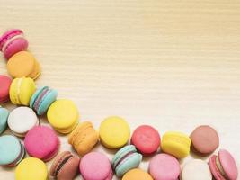 Colorful macaroon on wooden table. photo