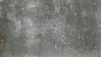 The old cement wall was weathered, the surface was scratched, the surface was scratched and damaged. For a mysterious retro-conservative background. photo
