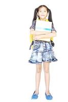 10 years old Asian schoolgirl standing and holding book isolated over white