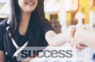 Welcoming business woman giving a handshake and smiling photo