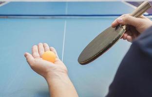 A man play table tennis ready to serve photo