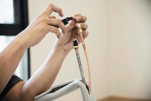 Man is installing wall compressor of air conditioner during hot season photo