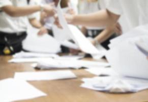 Blurred of student are submitting their examination paper in the classroom photo