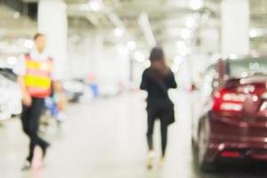 foto borrosa de una mujer caminando peligrosamente en una zona de aparcamiento