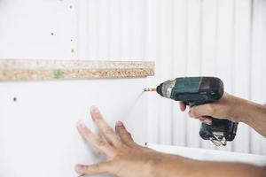 Man preparing electric router laminate trimmer machine tool - carpenter workshop concept photo