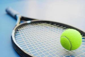 Tennis racket with ball on court photo