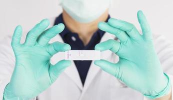 Doctor show rapid antigen test Covid -19 self rapid test set with single C stripe indicator means NEGATIVE UNINFECTED result photo