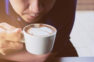 Businessman drinking coffee in a coffee shop photo