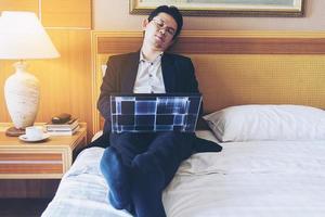 Business man take a nap while working in hotel room photo