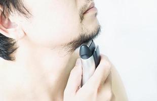 Man is using shaver photo