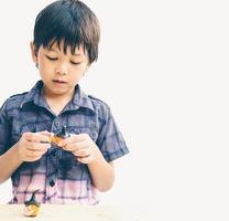 Vintage style of Asian lovely boy is playing Halloween clay happily photo