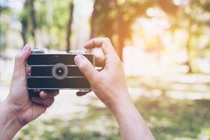 Man taking photo using old retro camera