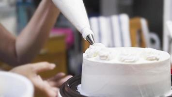 Lady making cream cake - people with homemade bakery concept photo