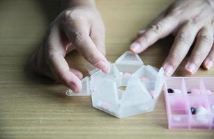 Woman prepare to eat periodical daily medicine pill - people healthcare with medicine pills concept photo