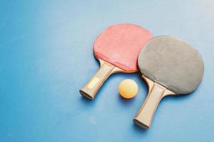 Table tennis equipment on blue table photo