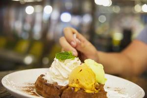 People eating ice cream scoop with waffle on white plate - people with fresh relax sweet ice cream concept photo