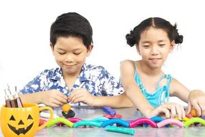 Boy and girl are happily playing clay toy photo