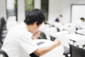 Blurred picture of student in the examination room photo