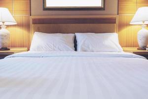 White bedding and towel set in modern hotel photo