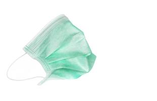 Green medical mask isolated over white background, Covid -19 protection background concept photo