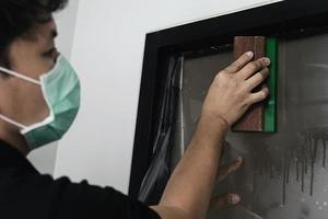 People installing sticker film to mirror window house interior decoration photo