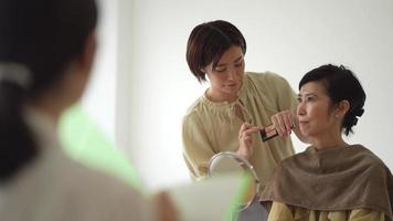 A woman giving a make-up class video