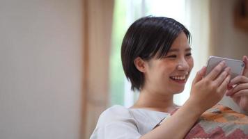 A woman watching a video on her smartphone