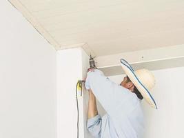 Soft focus photo of a man is working with ceiling installation in construction site