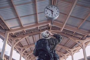 Travel man is waiting train at train station, Chiangmai Thailand, 23 May 2019 photo