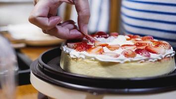 Lady making cream cake - people with homemade bakery concept photo