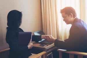 Businessman discussing with his secretary photo