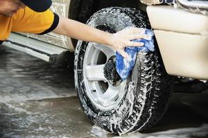 Man wash car using shampoo - every day life car care concept photo