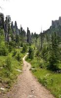 Winding Pathway Up to Towering Rocks on a Summer Day photo