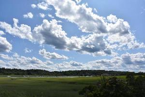 Fluffy Clouds Over North River in New England photo