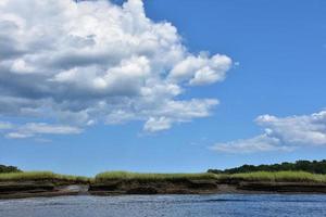 Fluffy White Clouds Over Marsh and Tidal River photo