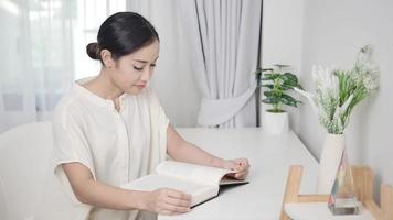 A freelance translator using a laptop sits on a kitchen table in self-quarantine. work for personal growth video