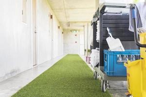 Cleaning equipment cart in hotel green corridor photo