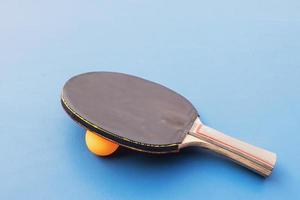 Table tennis equipment on blue table photo
